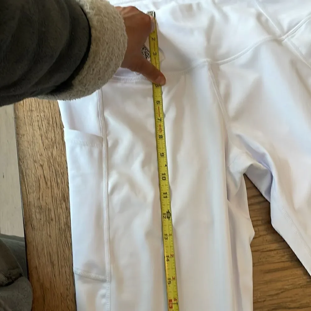 Kcutteyg white exercise capris with side pockets.  New with tags